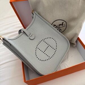 Hermès
Bleu Pale Clemence Mini Evelyne II TPM 16 Gold Hardware